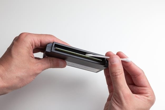 A close-up shot of a Nintendo Switch game cartridge being carefully inserted into a cartridge reader connected to a PC. The focus is on the act of creating a personal backup of a legitimately owned game, emphasizing the ethical approach to emulation.